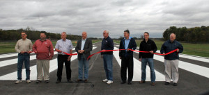 Plymouth officials cut the ribbon to dedicate the widened airport runway. 