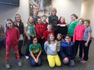 Menominee Elementary School Fourth graders present the profits made from working in the school store to United Way. Front, Left to Right: Lily Macy, Skye Shook, Izabella Baldwin, Myla Hamater, Diego Gifford, Mackenzie Dohner, Reina Sanderson, Cray Barden, Serenity Harding, Max Lewandowski, Annie Plothow, Clara Smith, Madison Hauptmann, and Sophie Wray, Linda Yoder and Susan Wagner.