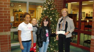 Riverside Intermediate School Student Council United Way Committee members present check from fundraising efforts to United Way. Pictured are Nena Roberts, Roman Snedeker, Rachel Ray, and Linda Yoder