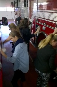 Students clean fire truck at Plymouth Fire Department.
